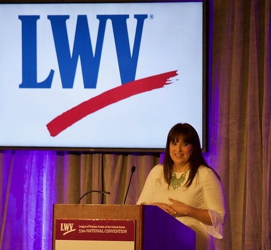 Virginia Kase Solomon standing at a podium at the 2018 Convention in Chicago, IL