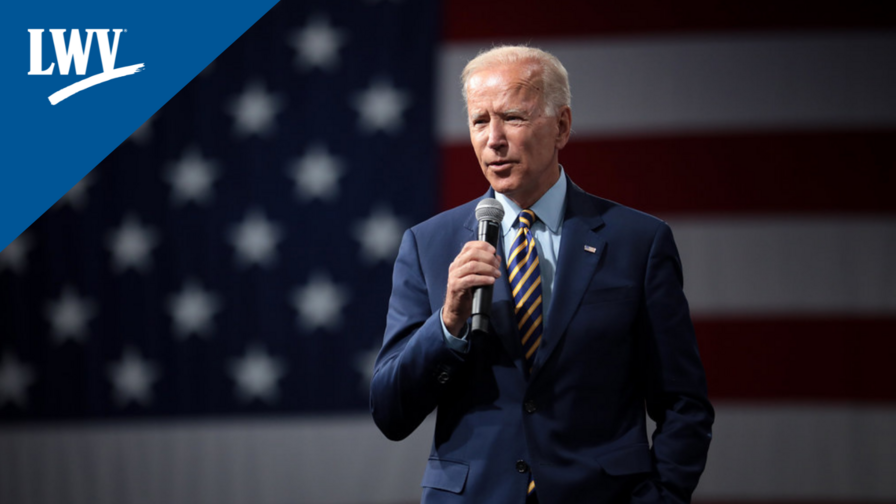 President Biden speaking into a microphone