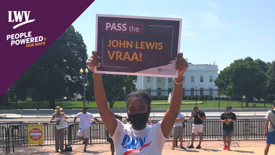 LaQuita Howard holding a VRAA sign